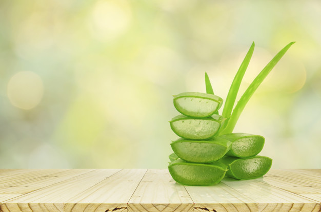 Aloe Vera on product display wood counter background.